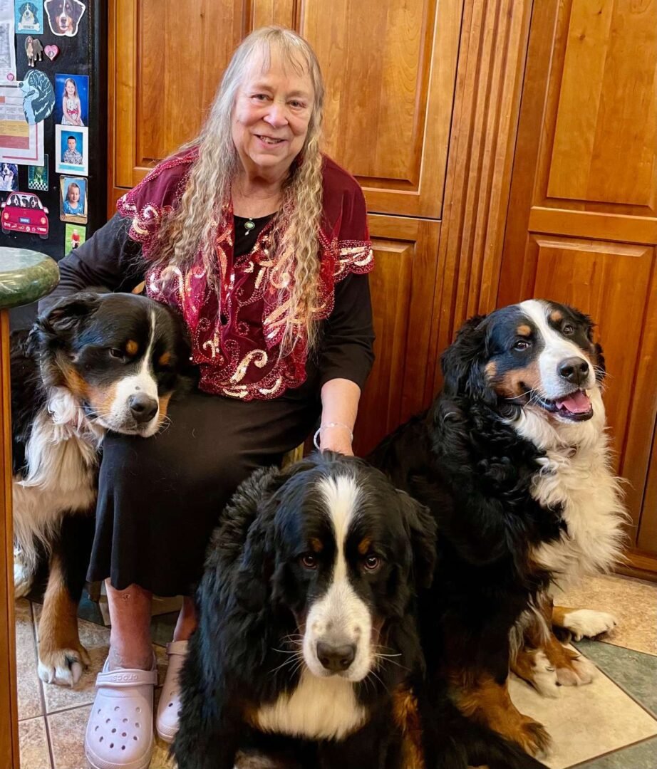 The In Joy Dogs breeder with three of her Bernese Mountain Dogs