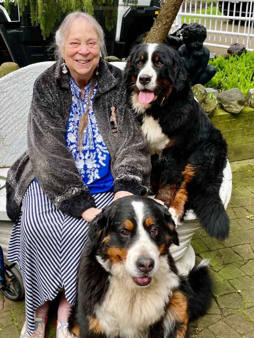 In Joy Dogs breeder with two Bernese Mountain Dogs